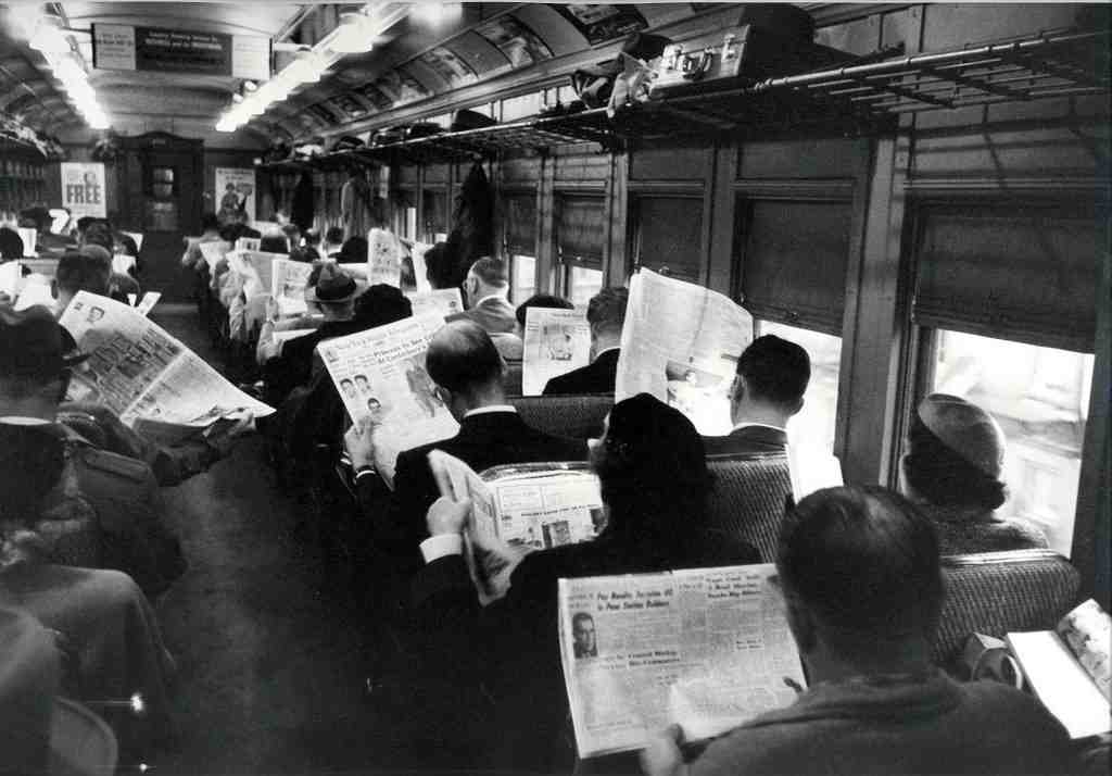 black and white photo of people on a train in the 1940s